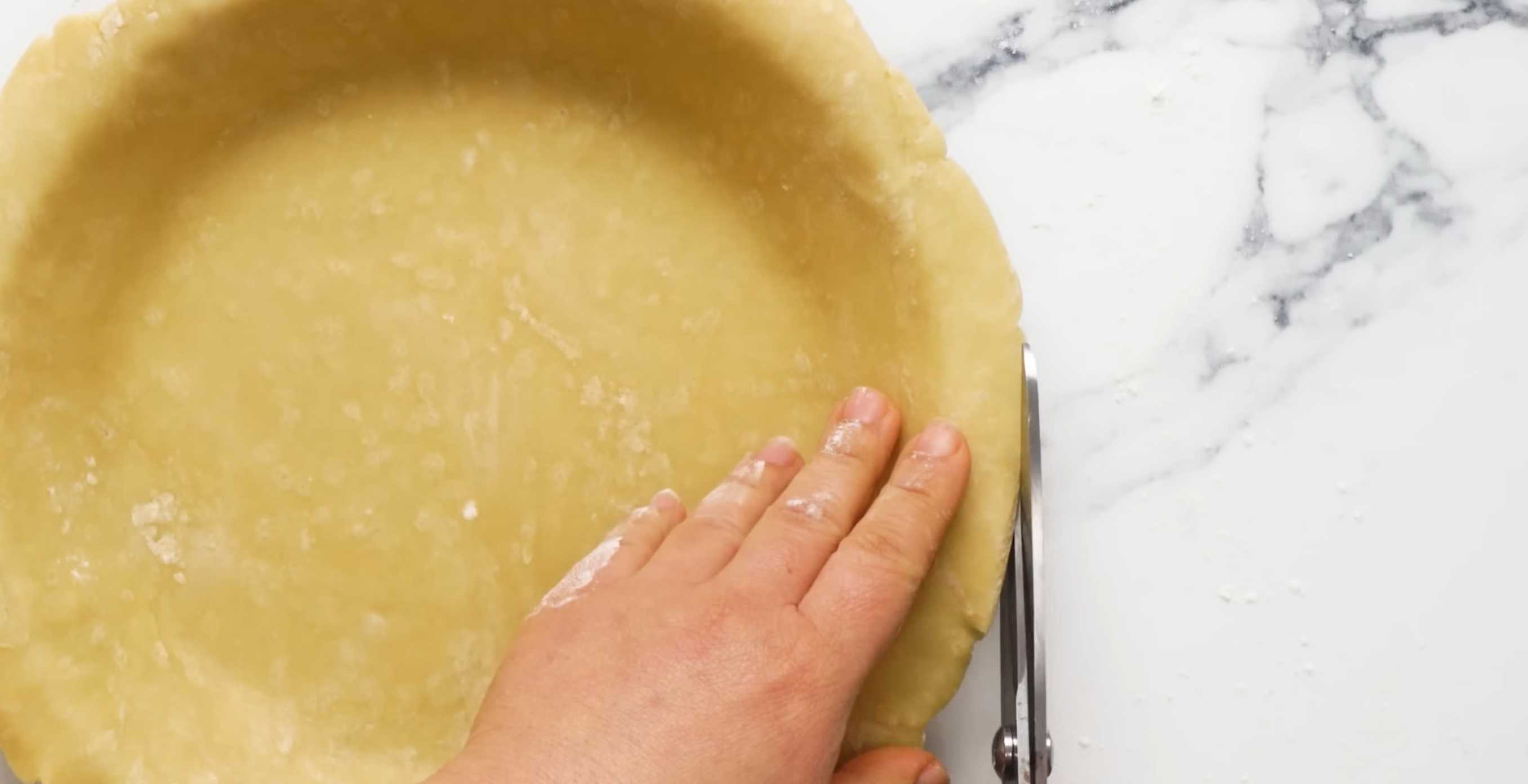 Раскатайте порцию песочного теста и застелите им круглую форму для выпечки, обмяв тесто внутри по периметру. Обрежьте неровные края. Семейный мясной пирог-Шаг 12